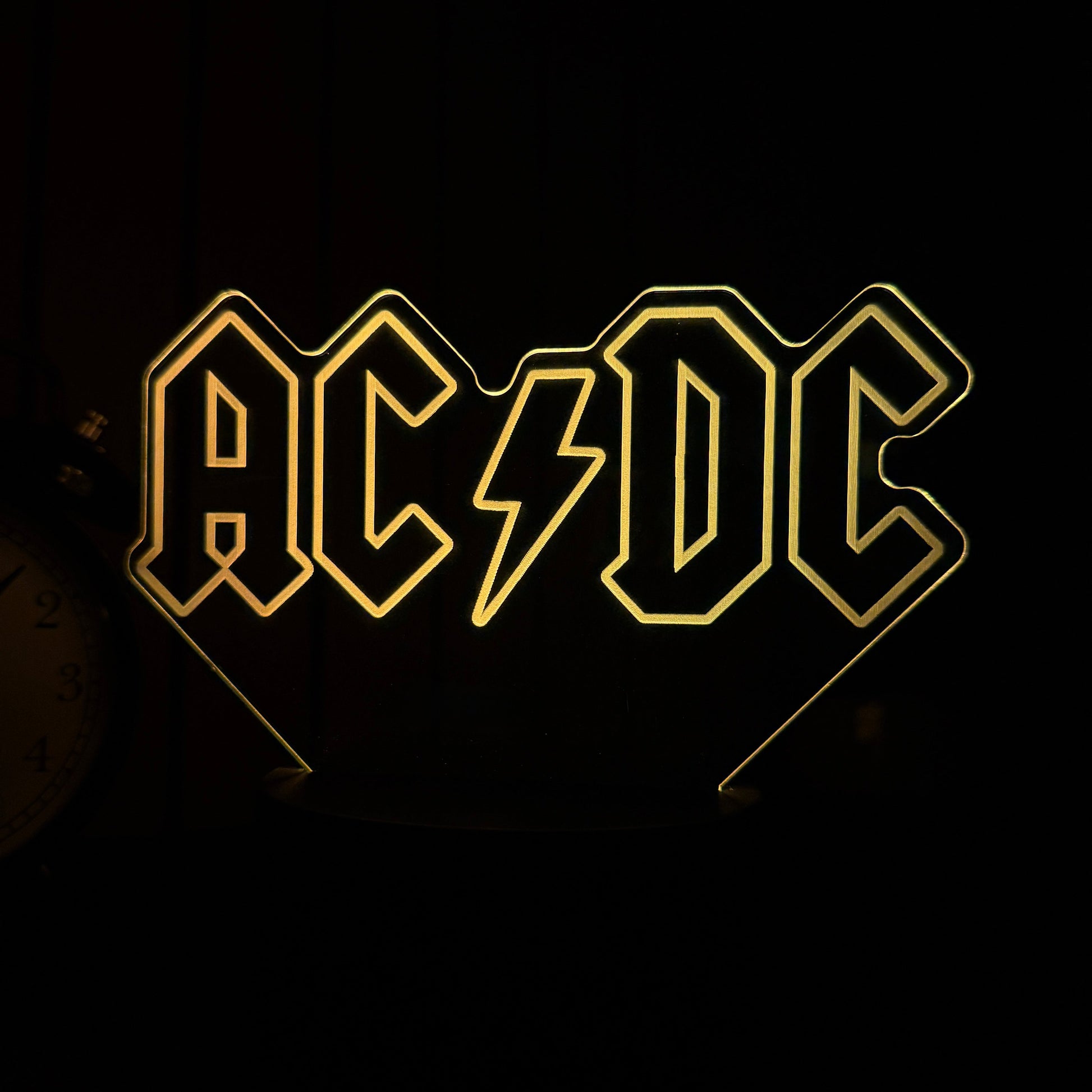 Neon sign with AC/DC logo on a black background