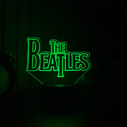 Green 'The Beatles' logo on a dark background