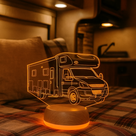 Camper-shaped night light on a plaid surface with a warm glow